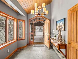 Step into this inviting entryway, showcasing a blend of rustic charm and modern elegance.