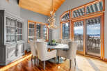 This stunning dining room boasts a unique antler chandelier, creating a focal point above the elegant round dining table.