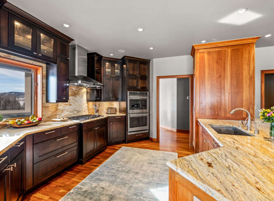 This stunning kitchen boasts custom cabinetry and granite countertops, creating a luxurious and functional space.