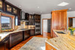 This stunning kitchen boasts custom cabinetry and granite countertops, creating a luxurious and functional space.