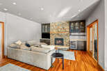 This stunning living room boasts a cozy fireplace with a stone facade, perfect for those chilly evenings.