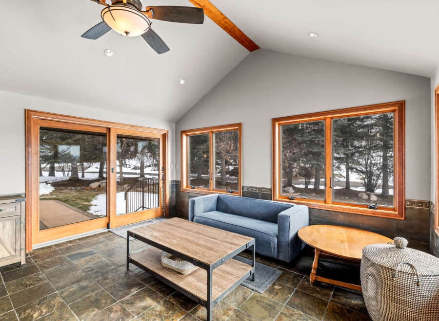This stunning sunroom offers a serene retreat with its natural light and inviting ambiance.