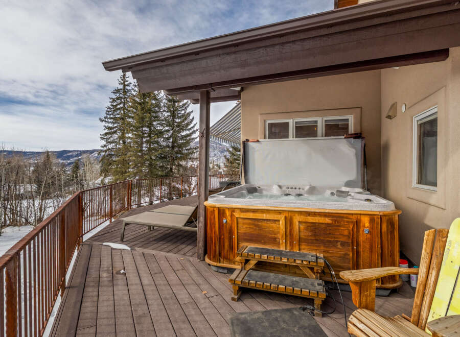 Enjoy the ultimate relaxation in this stunning property featuring a luxurious hot tub on a spacious deck.