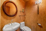 This stunning powder room showcases a unique cork wall design, creating a warm and inviting atmosphere.