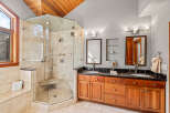 Step into luxury with this stunning bathroom featuring a spacious glass-enclosed shower and elegant double vanity.