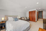 This spacious bedroom features a comfortable bed with stylish bedding and decorative pillows.