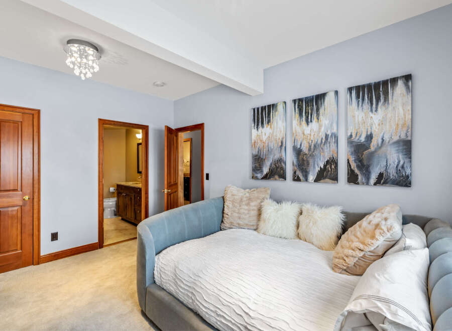 This stunning property features a beautifully designed bedroom with a cozy daybed, perfect for relaxation.