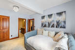 This stunning property features a beautifully designed bedroom with a cozy daybed, perfect for relaxation.