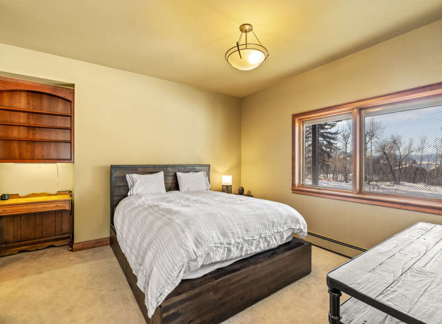 This inviting bedroom features a cozy bed, perfect for a relaxing retreat.