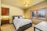 This inviting bedroom features a cozy bed, perfect for a relaxing retreat.