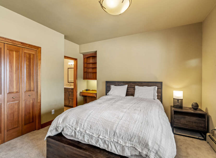 This inviting bedroom features a cozy bed with a stylish headboard, perfect for relaxation.