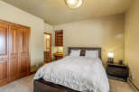 This inviting bedroom features a cozy bed with a stylish headboard, perfect for relaxation.