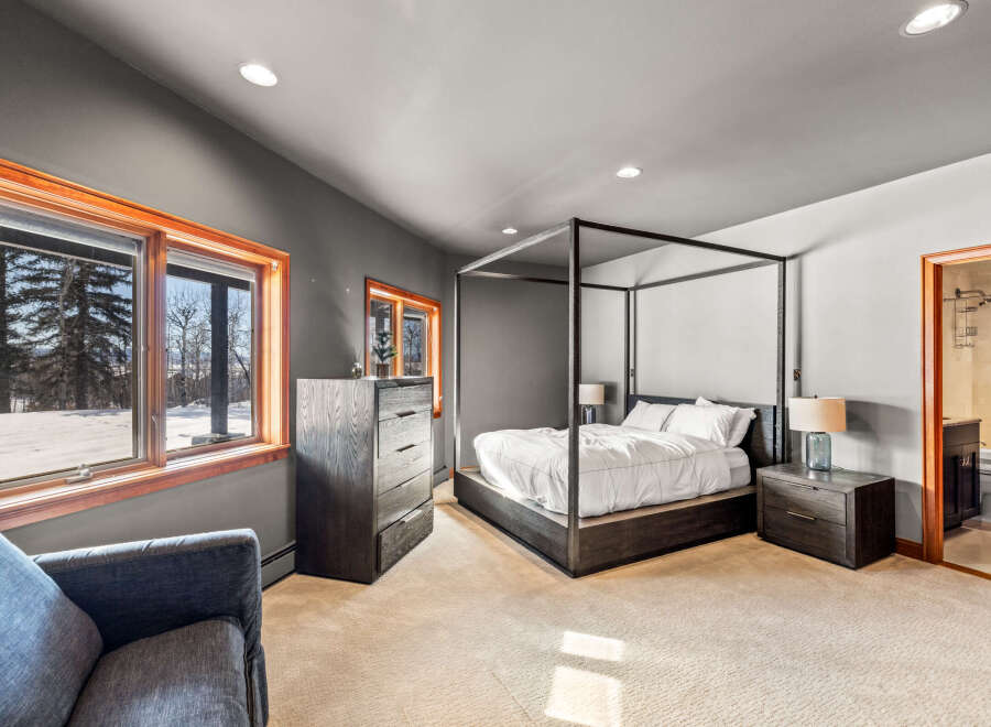 This stunning bedroom features a luxurious four-poster bed, creating a serene and elegant atmosphere.