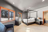 This stunning bedroom features a luxurious four-poster bed, creating a serene and elegant atmosphere.