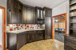 This stunning kitchen boasts custom dark wood cabinetry, offering ample storage and a sophisticated aesthetic.
