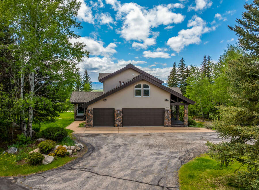 Nestled amidst lush greenery and mature trees, this charming home offers a serene retreat.