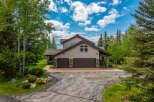 Nestled amidst lush greenery and mature trees, this charming home offers a serene retreat.