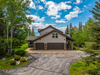 Nestled amidst lush greenery and mature trees, this charming home offers a serene retreat.