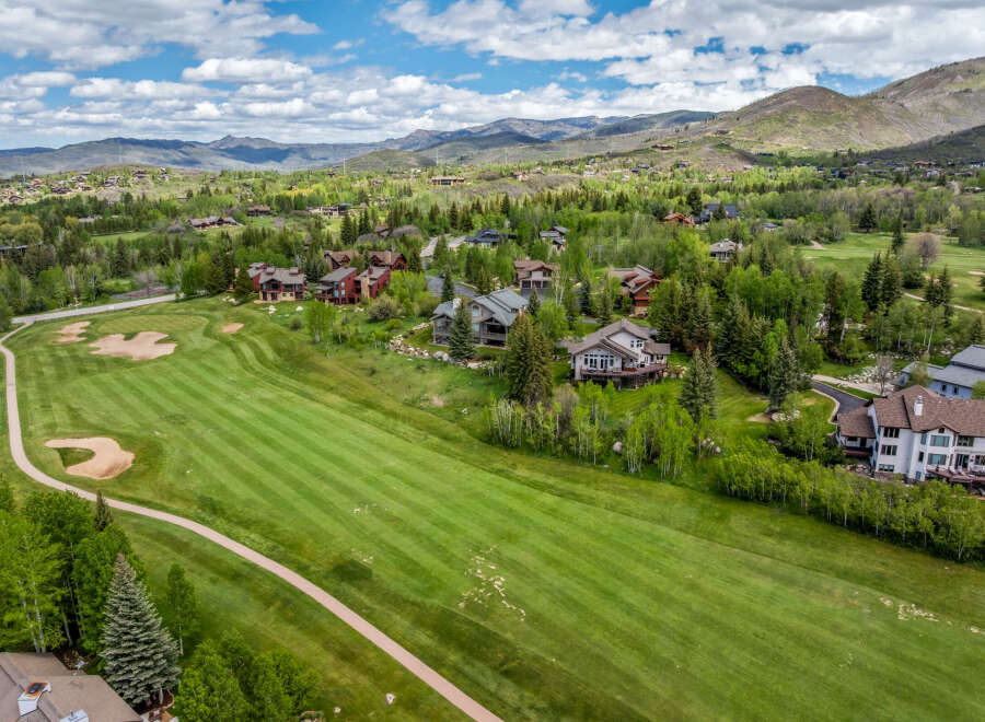 Experience luxury living nestled amidst rolling green hills and majestic mountains.