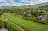 Experience luxury living nestled amidst rolling green hills and majestic mountains.
