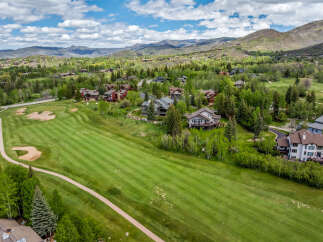 Experience luxury living nestled amidst rolling green hills and majestic mountains.