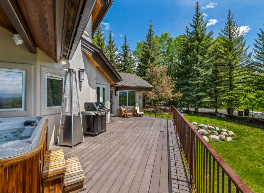 Enjoy outdoor living at its finest on this expansive deck, complete with a relaxing hot tub and a built-in grill perfect for entertaining.
