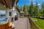 Enjoy outdoor living at its finest on this expansive deck, complete with a relaxing hot tub and a built-in grill perfect for entertaining.