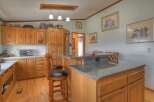 This charming kitchen boasts beautiful wooden cabinetry, offering ample storage and a warm, inviting atmosphere.