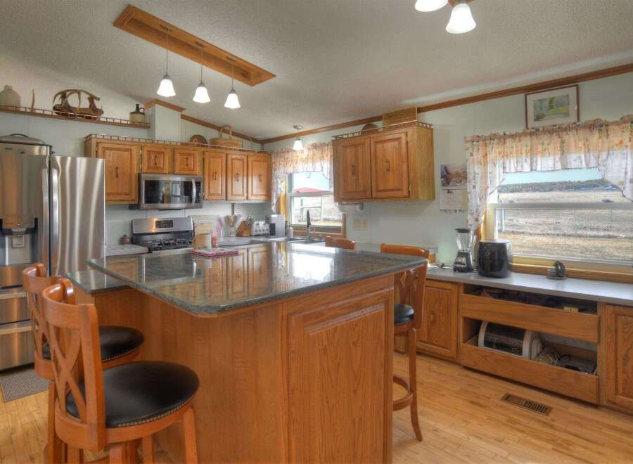 This charming kitchen boasts a warm and inviting atmosphere, perfect for culinary creations and family gatherings.