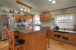 This charming kitchen boasts a warm and inviting atmosphere, perfect for culinary creations and family gatherings.