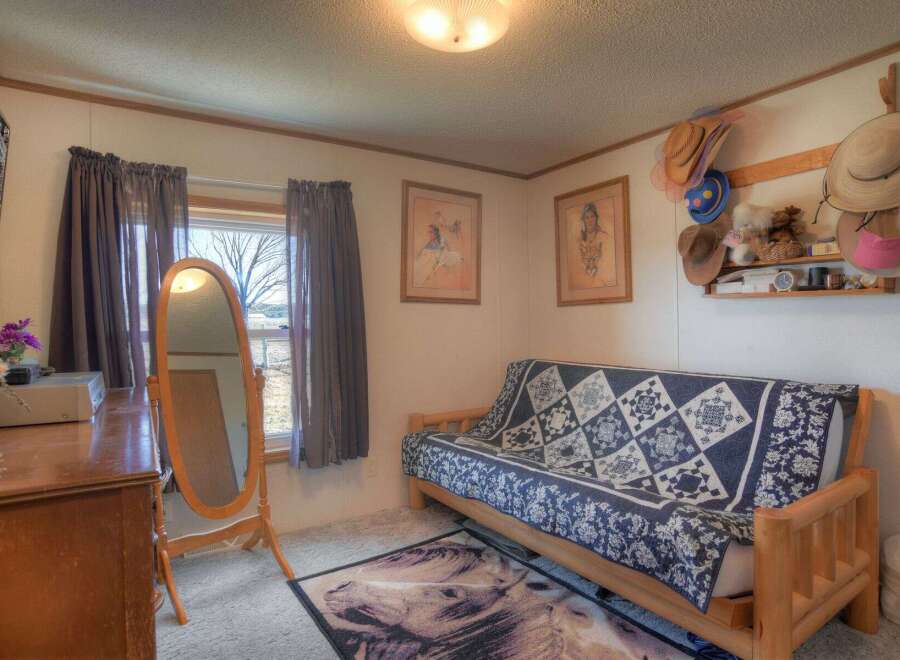 Step into this cozy bedroom, featuring a comfortable futon and a charming aesthetic.