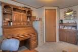 This charming property boasts a beautifully crafted wooden desk with ample storage, perfect for a home office or creative space.