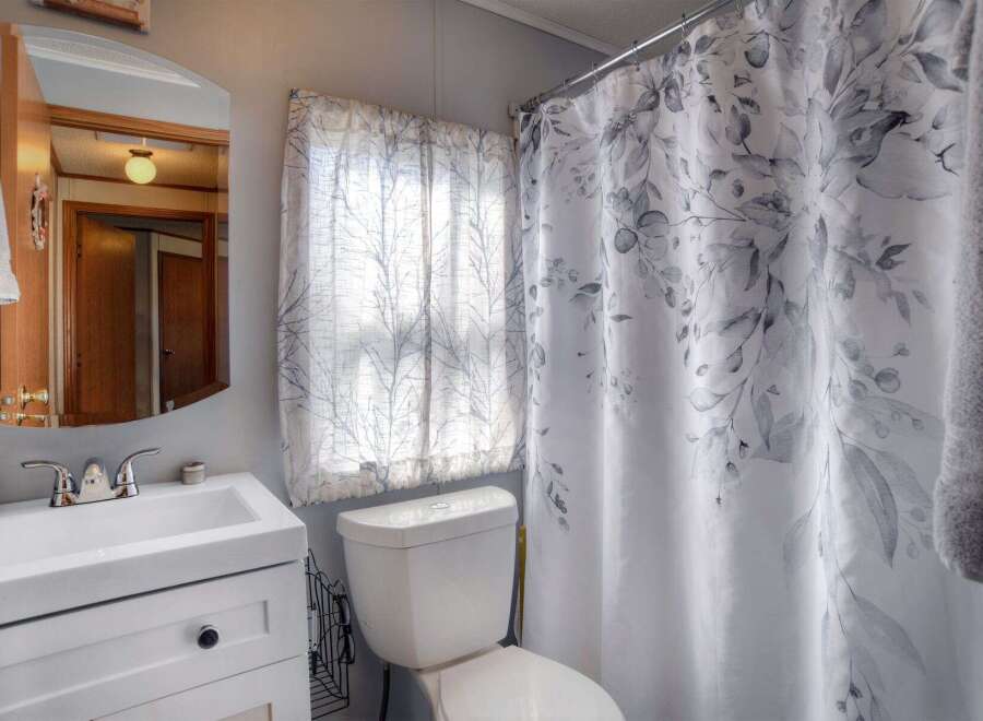 This charming bathroom features a bright and airy design, perfect for relaxation.