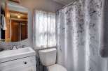 This charming bathroom features a bright and airy design, perfect for relaxation.