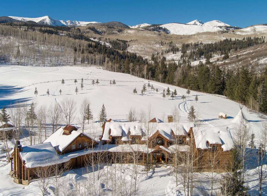 Nestled in a winter wonderland, this stunning property boasts a luxurious log cabin design, perfect for those seeking a mountain retreat.