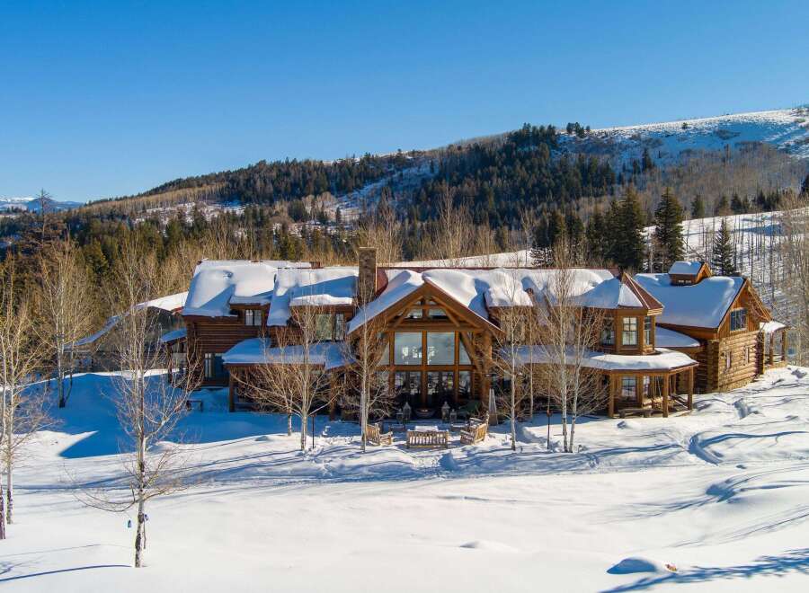 Experience luxury living in this stunning log cabin nestled in a winter wonderland.
