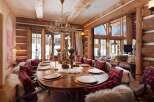 Step into rustic elegance with this stunning dining room, featuring a grand wooden table perfect for gatherings.