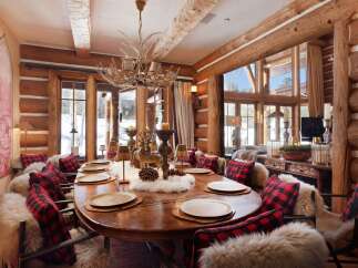 Step into rustic elegance with this stunning dining room, featuring a grand wooden table perfect for gatherings.