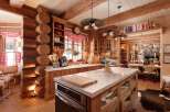 This stunning kitchen showcases rustic elegance with its log cabin design and modern amenities.