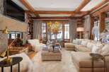 Step into luxury with this stunning living room, featuring a cozy fireplace and a plush, inviting sofa.