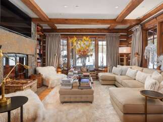 Step into luxury with this stunning living room, featuring a cozy fireplace and a plush, inviting sofa.