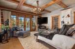 Experience luxury in this stunning bedroom featuring a rustic design with wooden beams and a cozy ambiance.