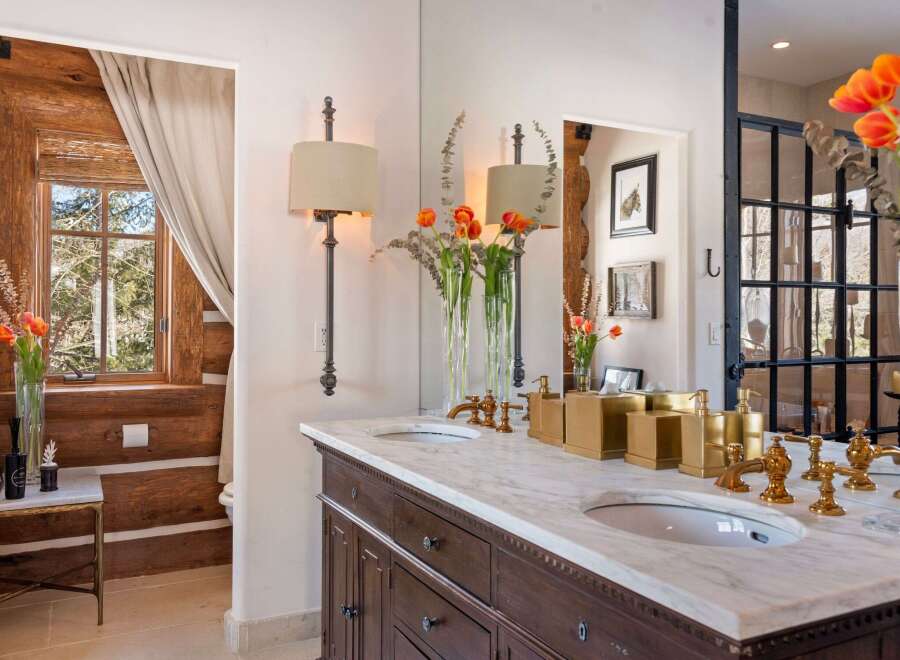 Step into luxury with this stunning bathroom featuring a marble countertop and elegant fixtures.