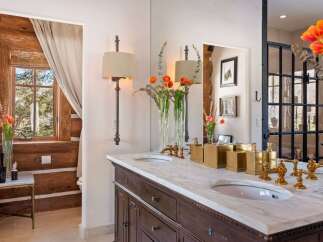 Step into luxury with this stunning bathroom featuring a marble countertop and elegant fixtures.