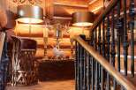 Step into rustic elegance with this stunning property, showcasing a beautifully crafted wooden staircase and warm, inviting log walls.
