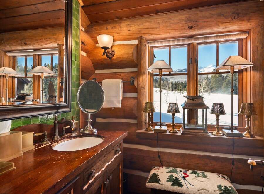 This rustic bathroom exudes warmth and charm with its log cabin aesthetic.