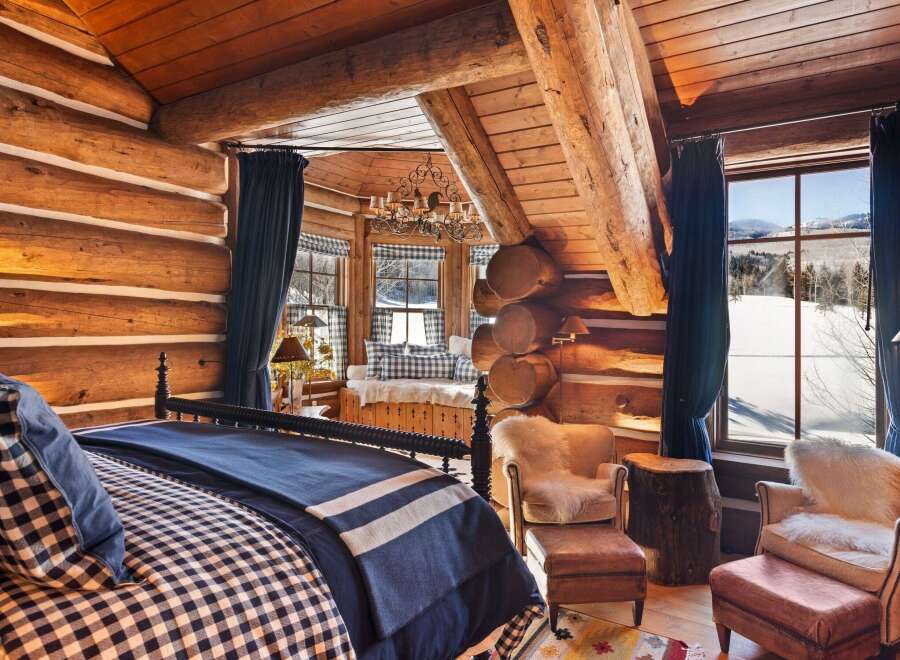 Step into rustic luxury in this stunning log cabin bedroom.