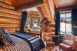 Step into rustic luxury in this stunning log cabin bedroom.