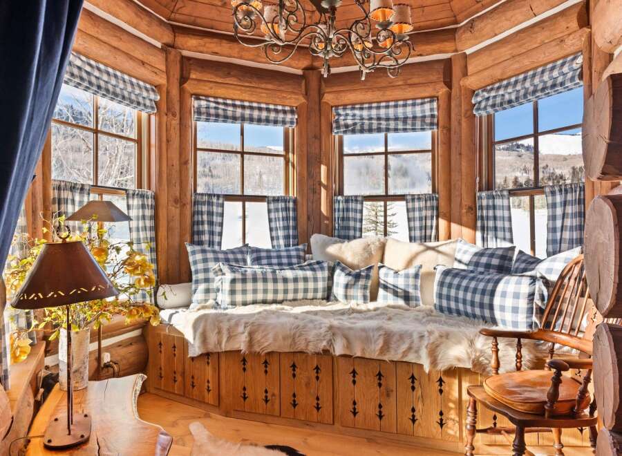 Step into a cozy retreat with this charming property, featuring a rustic interior with exposed wooden beams and a warm, inviting atmosphere.