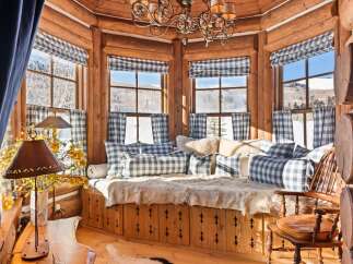Step into a cozy retreat with this charming property, featuring a rustic interior with exposed wooden beams and a warm, inviting atmosphere.